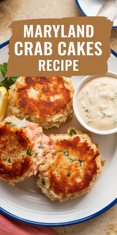 crab cakes on a plate with sauce and lemon wedges