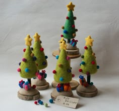 three small christmas trees are on display