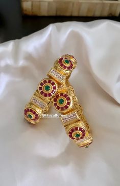 Gorgeous South Indian temple jewelry Kada Openable Bangle (SINGLE) with any Traditional Indian Ethnic wear to get lot of compliments on your way.  WHAT GOES IN  👉🏻Brass Bangles in Gold Polish with ruby, emerald colored stones & high quality CZ stones. 👉🏻Size: 2.4 openable fits bangle size 2.4 & 2.6 👉🏻Size: 2.6 openable fits bangle size 2.6 &. 2.8 ✅Check our collection here: https://www.etsy.com/shop/KKsCulture 💕CARE TIP  1. Keep away from moisture and perfume. 2. Store in cotton or zip lock bags or air tight boxes.  3. Spot cleaning only.  4. Jewelry is the last thing you should wear and the first thing you should remove.  ✅ SHIPPING & TURNAROUND  👉🏻Please allow 1-2 business days for item to be dispatched. All shipments come with valid USPS tracking number.  👉🏻All pre orders wil Bohemian Red Bracelets For Diwali, Red Bracelets For Navratri Rituals, Heavy Red Bracelets For Diwali, Red Heavy Bracelets For Festivals, Red Motif Jewelry For Rituals, Traditional Red Bangle For Rituals, Red Jewelry With Motifs For Rituals, Red Motifs Jewelry For Rituals, Red Bracelets For Navratri Celebration