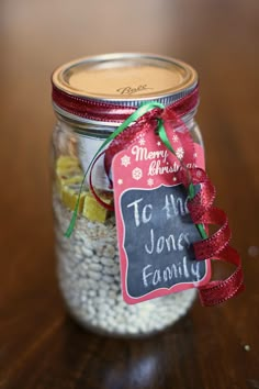 a jar filled with some kind of food on top of a wooden table next to a sign