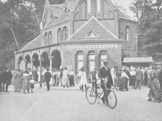 an old black and white photo of people in front of a building