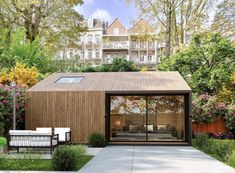 a small wooden house in the middle of a garden