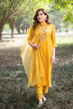 Highlights Handmade Color: Yellow Product Type: Kurta, Pant & Dupatta Fabric: Cotton Silk Embroidered: Zardozi Work, Red, Golden & White Beads Style: Straight Neckline: collar neck design Occasion: Festive Wear Sleeves: 3/4 Sleeves Length: Calf Length Gender: Women Pattern: Embroidered Package contains: Kurta & Pant with Orgenja Dupatta Care Instructions: Hand Wash & Dry clean Description Our Zardozi Hand Work Kurti in Yellow is a testament to the artistry and craftsmanship of Zardozi's work. Intricate hand embroidery and the use of vibrant red, golden, and white beads create a mesmerizing pattern, adding opulence to your look. The straight style of the Kurti offers a flattering and contemporary silhouette, suitable for various body types. The collar neck design adds a touch of sophisticat Semi-stitched Yellow Kurta With Cutdana, Semi-stitched Yellow Palazzo Set In Chanderi, Yellow Cutdana Semi-stitched Kurta, Designer Yellow Kurta For Navratri, Yellow Palazzo Set With Straight Kurta For Eid, Yellow Straight Kurta Palazzo Set For Eid, Bollywood Style Yellow Palazzo Set With Cutdana, Yellow Anarkali Palazzo Set For Eid, Yellow Bollywood Palazzo Set With Cutdana