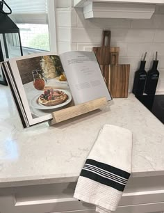 an open book sitting on top of a kitchen counter