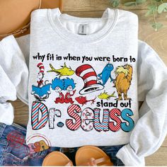 the dr seuss shirt is next to some shoes