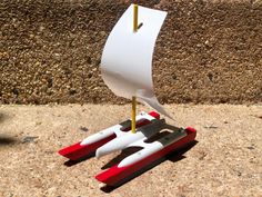 a pair of scissors sitting on top of a piece of paper next to a red and white object