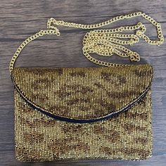 This chic mini clutch features a gold cheetah pattern and a gold strap for a wild and stylish look. Perfect for going out, this clutch bag is a great way to bring your essentials while looking fashionable. Measurements: 7”L x 0.5”W x 5”HChain Strap Measurement: 45” Trendy Gold Evening Bag With Detachable Strap, Gold Pouch Clutch With Chain Strap, Gold Chain Strap Pouch Clutch, Gold Shoulder Bag With Adjustable Strap For Party, Gold Clutch Shoulder Bag For Fashion Accessory, Brown Party Clutch With Detachable Strap, Trendy Gold Pouch Clutch, Elegant Leopard Print Party Bag, Evening Shoulder Bag In Leopard Print With Detachable Strap