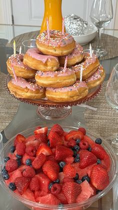 there are many donuts and strawberries on the table