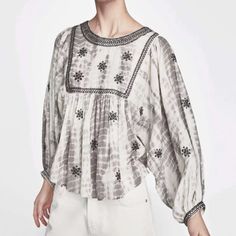 From Zara Comes This Embroidered And Embellished Boho Style Gray And White Tie Dye Blouse In Sz Small. In A Peasant Style Silhouette With 3/4 Balloon Sleeves, Dolman Style, Slightly Cropped Detail, Black Beading And Embroidered Detail Along Neckline And Yoke As Well As Sleeve Hems, Geometric Stitched Embroidery Throughout, Back Button Closure. Crew Neck. Measurements Bust Flat Approximately 23” Length 22”. White Puff Sleeve Embroidered Top For Summer, Chic Summer Tops With Embroidered Sleeves, Long Sleeve Embroidered Top For Summer, Chic Summer Top With Embroidered Sleeves, Fall Embellished White Tops, Chic Embroidered Zara Tops, Embroidered Puff Sleeve Tops For Fall, Embroidered Cotton Tops With Lantern Sleeves, Long Sleeve Blouse With Pearl Embroidery