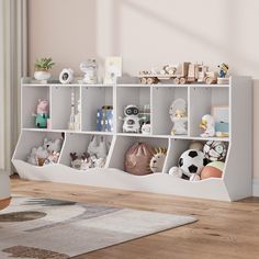 a white shelf filled with lots of stuffed animals