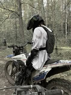 a person on a dirt bike in the woods