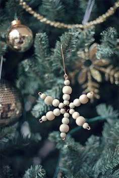 an ornament hanging from the top of a christmas tree