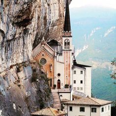 an old church on the side of a cliff