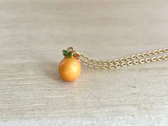 This dainty orange / tangerine necklace is made of the following: (1) Gold plated orange slice charm (charm size: 12 x 8.5mm) (2) Gold plated or 14KGF chain and findings ✏️ Please choose the length of the chain (the length includes clasp and findings) ✏️ Please choose your desired plating of chain ❣️ If you are unsure about which length to choose , please leave me a note to request an extension chain to be added to the chain at check out. 🍊EARRINGS 🍊 Threader -> https://www.etsy.com/listing Orange Pendant Charm Necklaces For Gifts, Orange Necklace With Adjustable Chain For Gift, Orange Necklace With Adjustable Chain As Gift, Orange Dainty Jewelry For Gifts, Dainty Orange Jewelry For Gifts, Dainty Orange Jewelry For Gift, Handmade Orange Charm Necklace As A Gift, Handmade Orange Charm Necklace For Gift, Daruma Doll