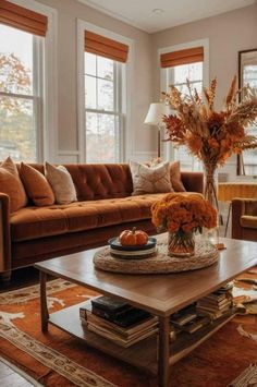 a living room filled with lots of furniture and flowers on top of a coffee table