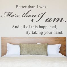 a bedroom with a bed and wall decal that says, better than i was more than