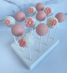 there are many pink and white cake pops