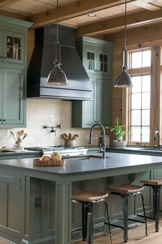 a kitchen with green cabinets and an island