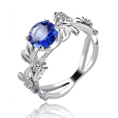 Lovely silver band made of delicate vines and flanked with small white rhinestones. Vines draw up in an elegant fashion to the blue gem center stone for a beautiful and timeless finish. Perfect for any occasion. Lead free. Elegant Blue Diamond Flower Ring, Elegant Blue Flower Ring For Formal Occasions, Elegant Blue Sterling Silver Flower Ring, Elegant Silver Flower Ring With Birthstone, Elegant Blue Sapphire Ring With Stone Setting, Elegant Blue Crystal Ring With Center Stone, Blue Gem Ring, Valentine Gifts For Girls, Sparkling Rings