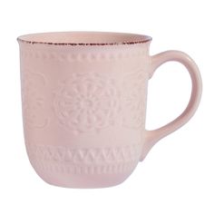 a pink coffee cup sitting on top of a white table