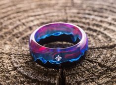 Wooden purple-pink resin ring with cubic zirconia Sirius |glow in the dark handmade nature jewelry| epoxy resin ring with mountain landscape Materials: black hornbeam, epoxy resin, wood size: Inner diameter from 15 to 24 mm The Sirius ring is made of walnut with a diamond-shaped cubic zirconia insert and blue epoxy resin with purple-pink streaks. Glows in the dark! To achieve the glow effect, charge under the lamp for at least 10 minutes. Recommendations for care Do not wash with water Luminous Ring Jewelry For Gifts, Luminous Ring Jewelry As A Gift, Purple Round Resin Jewelry, Pink Streaks, Emerald Ring Engagement Diamond, Edgy Jewelry, Landscape Materials, Glow Effect, Epoxy Resin Wood