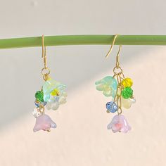 🍀 Size: 4.7 x 2.2 cm 🍀 Material: 14K Gold Plated Sterling Silver Hook, Brass, Glass (✨Hypoallergenic Hook✨) Description 🌸 Introducing our whimsical Cottagecore Rainbow Flower Earrings, a delightful accessory that captures the essence of nature and adds a touch of color and charm to your look. These earrings feature translucent lily of the valley flowers in vibrant rainbow hues, creating a captivating and unique design that embodies the spirit of cottagecore and Y2K fashion. 🌸 ⭐️ Shop more styles at https://etsy.com/uk/shop/StrawberryAtoll. ⭐️ * Shipping *  🇬🇧 Free shipping for UK orders. All our items will be shipped within 1-2 days.  * Packaging & Gift Wrap * 🎀 All our products are packaged with care and attention to detail. To make your purchase even more special, we offer an opti Whimsical Dangle Earrings With Flower Charm, Multicolor Dangle Earrings In Kawaii Style, Kawaii Drop Earrings, Kawaii Multicolor Dangle Earrings, Kawaii Dangle Earrings With Ear Wire, Cottagecore Accessories, Whimsical Cottagecore, Earrings Cottagecore, Earrings Y2k