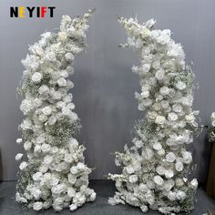 two white flowers are arranged in the shape of an arch