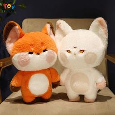 two stuffed animals are sitting on a chair