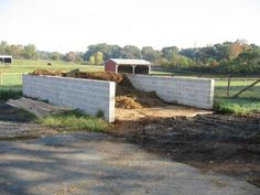 two concrete blocks are stacked on top of each other in the middle of a field