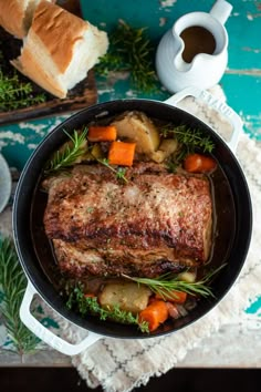 pork roast with potatoes and carrots in a cast iron skillet