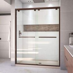 a bathroom with a glass shower door and sink