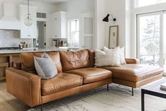 a living room filled with furniture and lots of windows