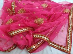 Neon Pink Lehenga dupatta for women wedding wear. Size: Dupatta is 100 inches (2.5 meter) long and 40 inches (1 meter) wide. Length of this dupatta can be customized as per your requirement. Fabric and work: Heavy sequins work net fabric with a mirror work lace border.Mirrors are not real they are foil mirrors. Delivery time: This dupatta will take 3-4 days to produce after we have received your order. While ordered with standard shipping it takes around 2-3 weeks in transit after we dispatch it Luxury Pink Dupatta With Mirror Work, Luxury Pink Dupatta With Self Design, Luxury Embroidered Pink Dupatta, Luxury Pink Embroidered Dupatta, Luxury Pink Dupatta For Festive Occasion, Luxury Pink Dupatta For Party Wear, Luxury Pink Dupatta For Party, Luxury Pink Dupatta For Transitional Season, Luxury Pink Dupatta For Evening