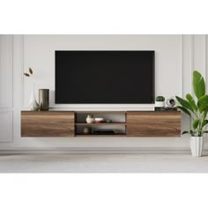 a large flat screen tv mounted to the side of a wooden entertainment center in a living room