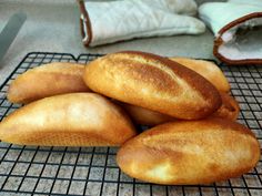 several loaves of bread sitting on a cooling rack