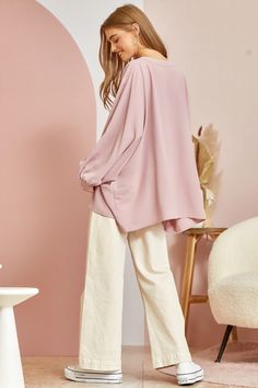 This blouse is out to prove that comfy and chic can coexist in perfect harmony. Its flowy, dolman cut gives you room to breathe while still maintaining a flattering drape. 3/4 sleeves keep it seasonal, transitioning effortlessly from summer to fall. A plunging V-neckline shows just enough skin to be subtly seductive, but the blush pink hue is as sweet and charming as an English rose garden. In short, this top lets you make a stylish statement without having to sacrifice one ounce of comfort. It’ Effortless Blouse For Spring, Feminine Blouse With Relaxed Fit In Solid Color, Oversized Long Sleeve Top For Spring Loungewear, Oversized Spring Blouse For Daywear, Oversized Blouse For Spring Daywear, Effortless Fall Blouse For Day Out, Effortless Fall Day Out Blouse, Oversized Versatile Blouse For Daywear, Versatile Oversized Blouse For Day