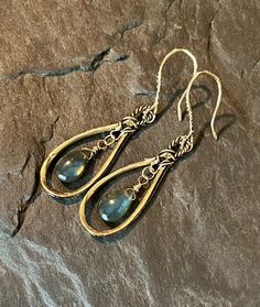 These beautiful, bohemian style dangles feature handcrafted, artisan, gold bronze hoops, with smooth, blue flash labradorite gemstones. The gems are wire wrapped in gold filled wire. The gorgeous ear wires are handcrafted in gold bronze. Total length is approximately 2 inches.  Earrings will arrive in a gift box.  Please ensure that your correct address is listed when you place your order. Terra Glass and Gems is not responsible for lost, stolen, damaged, or misplaced packages. Labradorite Earrings, Wire Jewelry, Ear Wires, Boho Style, Wire Wrapped, Bohemian Style, Favorite Jewelry, Labradorite, Jewelry Earrings Dangle