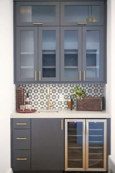 a kitchen with grey cabinets and white counter tops is shown on the instagram page