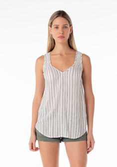 [Color: Off White/Black] A front facing image of a blonde model wearing a casual bohemian spring tank top in an off white and black stripe. With a v neckline Casual V-neck Tank Top For Vacation, Striped Sleeveless Tank Top For Vacation, Striped Summer Tank Top For Beach, Summer Striped Tank Top For Beach, Striped Summer Tank Top For The Beach, Striped Summer Tank Top For Vacation, Summer Striped Tank Top For The Beach, Striped V-neck Summer Tops, Striped V-neck Tank Top For Spring