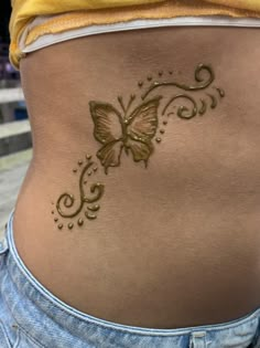 a woman's stomach with a butterfly tattoo on it