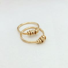 "A beautiful wire wrapped 14k gold filled ring. This delicate handmade gold filled ring with a special wire wrap texture at the top has a chic and sophisticated look. This ring looks great as a minimalist single piece, but will look even better when layered with other rings. This ring is made from high quality 14K \"Gold Filled\" - unlike \"gold plating\" the gold in gold filled jewelry is mechanically bonded to the base metal, and it will not wear off or turn black. This ring literally goes wit 14k Gold Filled Open Midi Rings As Gift, Minimalist Wire Wrapped Rose Gold Ring, Minimalist Rose Gold Wire Wrapped Ring, Elegant 14k Gold Wire Wrapped Rings, Simple Stackable 14k Gold Filled Rings, Adjustable Gold Stackable Rings With Wire Wrapping, Adjustable Gold Wire Wrapped Stackable Rings, Adjustable Gold Stackable Wire Wrapped Rings, Adjustable Hand Wrapped Gold Stackable Rings