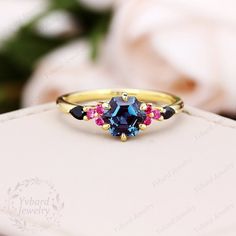 "Please confirm your US size when you make an order) ❤Jewelry Details -Gold Type: Solid 10K Gold / Solid 14K Gold / Solid 18K Gold (Choose One in Material Option) Center Stone: Natural London Blue Topaz, approx. 1.25ct Stone Size: 6*6mm Cut: Hexagon Cut Side Stones: Natural Ruby, Natural Black Sapphire Total weight: 0.22ctw Band Width: Approximately 1.5mm SKU: YR0623 ~*-*~Purchase Guarantee: - All our jewelry is handmade, and each process is refined. - 14 Day Refund Guarantee. - All our products