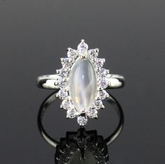 This Sterling Silver Ring features an Elegant Art With Natural Moonstone Gemstone. The cavity is made from genuine solid 925 sterling silver and stamped as S925. This Jewelry is Lead free and Rhodium Plated to keep polish long time and Scratches free. ITEM DESCRIPTION Item Code: JARG337/12 Metal: 925/92.5 Sterling Silver Gemstone: Genuine Natural Moonstone Cabochon Gemstone Shape: Marquise Gemstone Size: 6 X 12 MM Ring Length: 18 MM Ring width: 11 MM Second Stone: Cubic Zirconia Weight: 3.2 gm a Silver Moonstone Ring Hallmarked, Elegant Silver Moonstone Ring With Stone Setting, Silver Sterling Silver Moonstone Ring, Silver Sterling Moonstone Ring Fine Jewelry, Fine Jewelry Silver Moonstone Ring In Sterling Silver, Fine Jewelry Silver Hallmarked Moonstone Ring, Silver Moonstone Ring In Fine Jewelry Style, Silver Moonstone Ring For Formal Occasions, Silver Moonstone Rings In Fine Jewelry Style