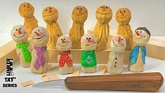 a group of wooden snowmen standing next to each other on top of a table