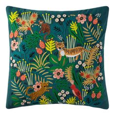 a green pillow with animals and plants on it