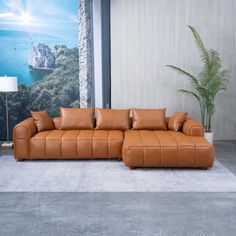 a living room with a brown leather couch and large painting on the wall behind it