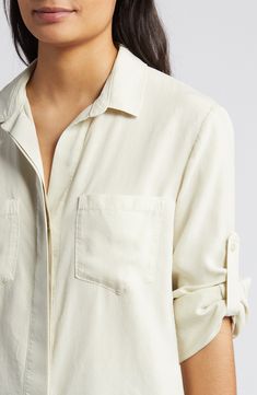 A split back adds soft movement to this slightly oversized button-up shirt cut from a silky, buttery-soft fabric with an eye on sustainability. 25" length Hidden-button placket Spread collar Long sleeves with roll-tab cuffs Chest patch pockets 100% Tencel® lyocell Tencel lyocell is a sustainably produced fiber made with closed-loop processing Machine wash, tumble dry Imported Women's Clothing Fashion Library, Dress Stitching, Neck Designs For Suits, Bella Dahl, Wide Jeans, Cut Shirts, Button Shirt, Button Placket, Neck Designs