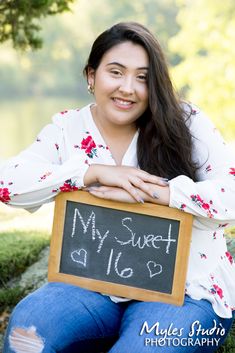 a woman holding a chalkboard that says my sweet life