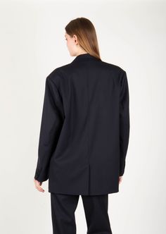 Product Description: Elevated take on a workwear staple with this oversized blazer. The design has an elongated single-breasted silhouette and two flap pockets in the front. It has drop shoulder and oversized fit that borrows from masculine styles. Wear yours with everything from denim to midi dresses. Fabric: 97% Wool ; 3% Spandex Color: Black Size and Fit: Our model is 5'10" and is wearing a size XS. Oversized Fit Care Instructions: Dry clean Only Business Blazer With Concealed Front Fastening And Suit Collar, Oversized Single Breasted Blazer For Office, Oversized Outerwear With Suit Collar For Office, Structured Blazer With Concealed Front Fastening For Work, Oversized Lapel Collar Blazer For Business Casual, Oversized Business Casual Blazer With Lapel Collar, Oversized Blazer With Lapel Collar For Business Casual, Modern Business Blazer With Concealed Front Fastening, Oversized Blazer With Double Button Closure