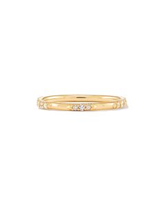 a yellow gold ring with three diamonds on the inside and outside, set against a white background